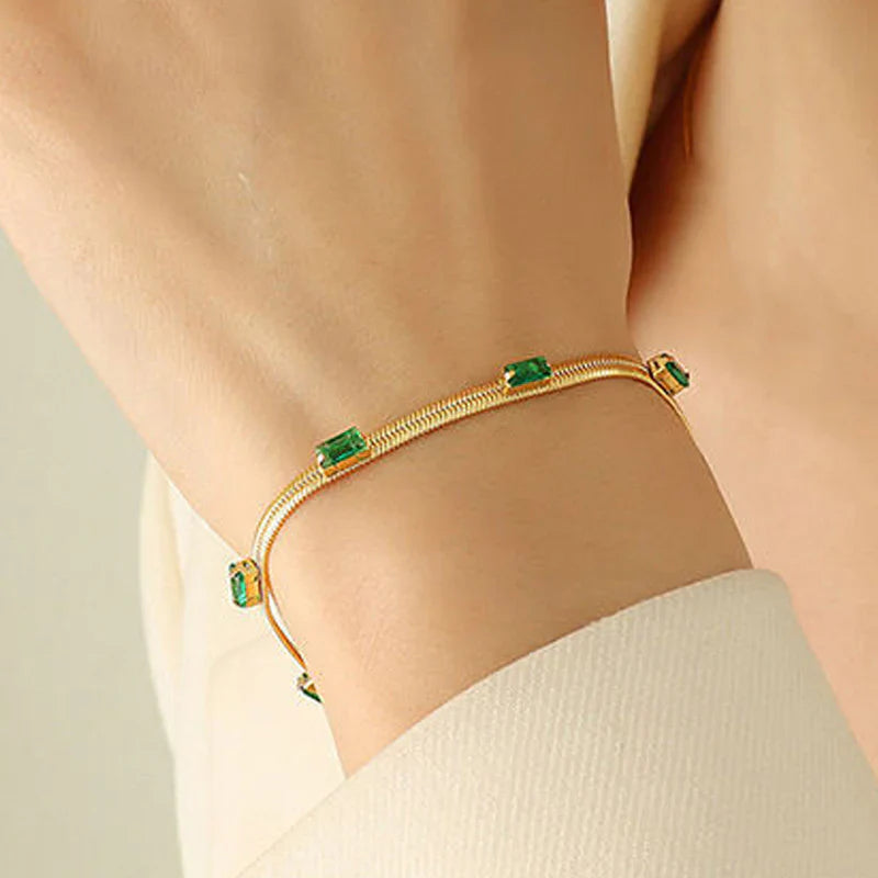 Elegant Gold Snake Chain Bracelet with Green Baguette Stones
